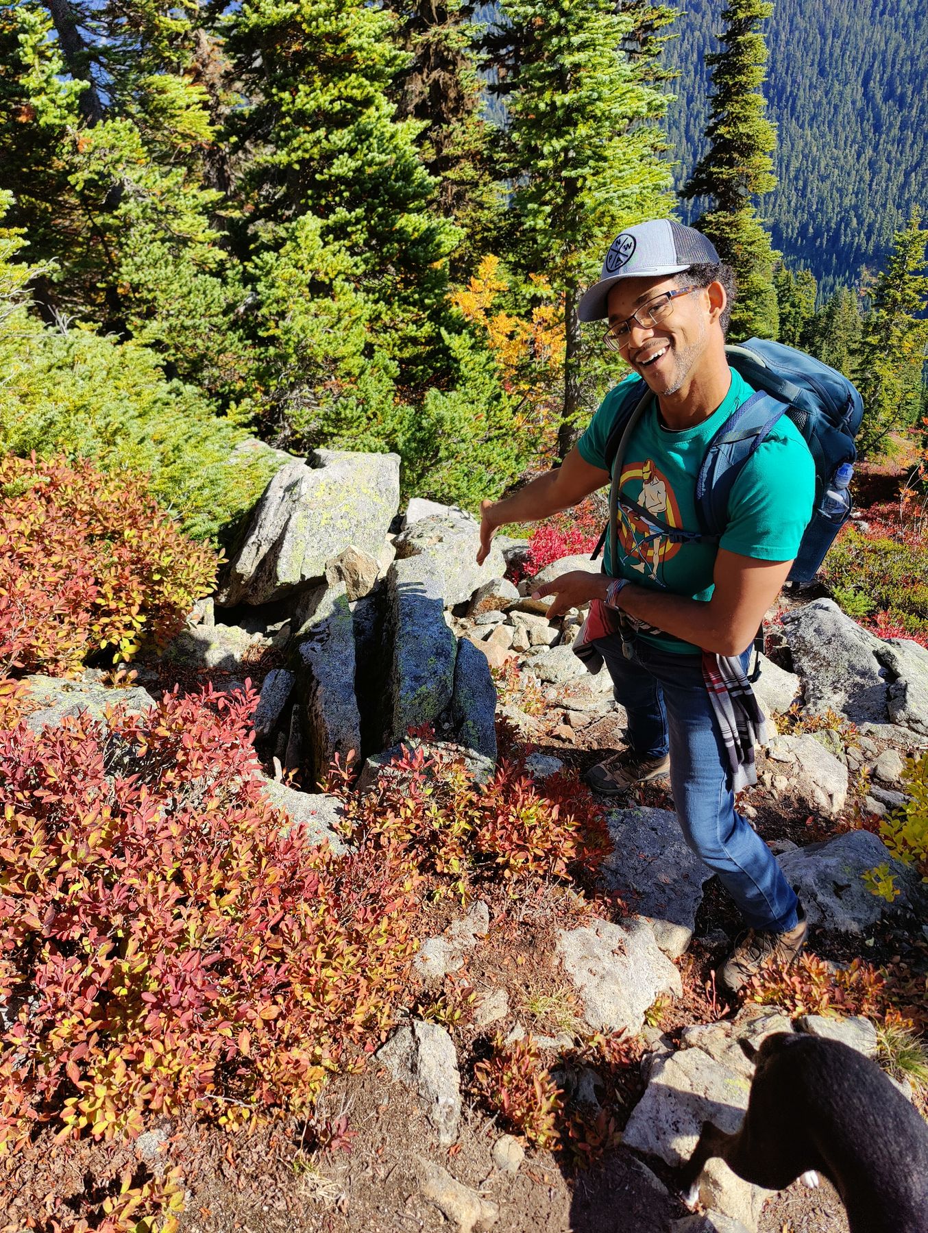 Aaron on the rocky summit with fall foliage